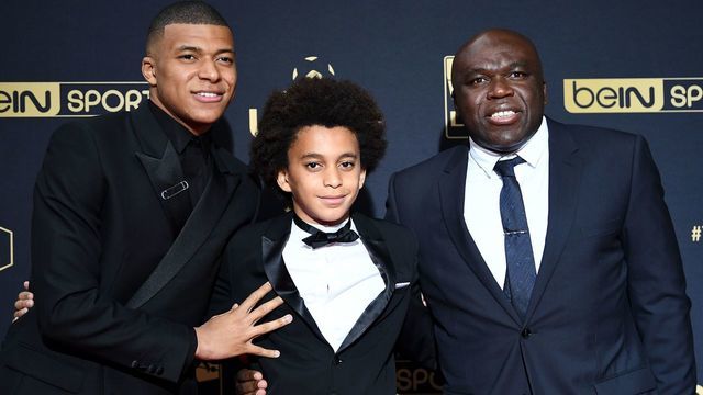 Paris Saint-Germain's French forward Kylian MBappe, father Wilfried Mbappe and his brother Ethan pose before he receives the Best Ligue 1 Player award during the TV show on May 19, 2019 in Paris, as part of the 28th edition of the UNFP (French National Professional Football players Union) trophy ceremony.