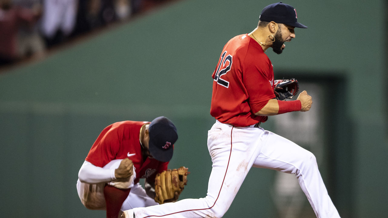 BOSTON, MA - JUNE 25: Marwin Gonzalez #12 and Xander Bogaerts #2 of the Boston Red Sox react after turning a double play to end the game against the New York Yankees on June 25, 2021 at Fenway Park in Boston, Massachusetts.
