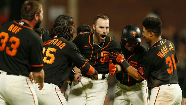 SAN FRANCISCO, CALIFORNIA - JUNE 26: Curt Casali #2 of the San Francisco Giants celebrates with teammates after hitting a walk-off RBI double in the bottom of the tenth inning against the Oakland Athletics at Oracle Park on June 26, 2021 in San Francisco, California.
