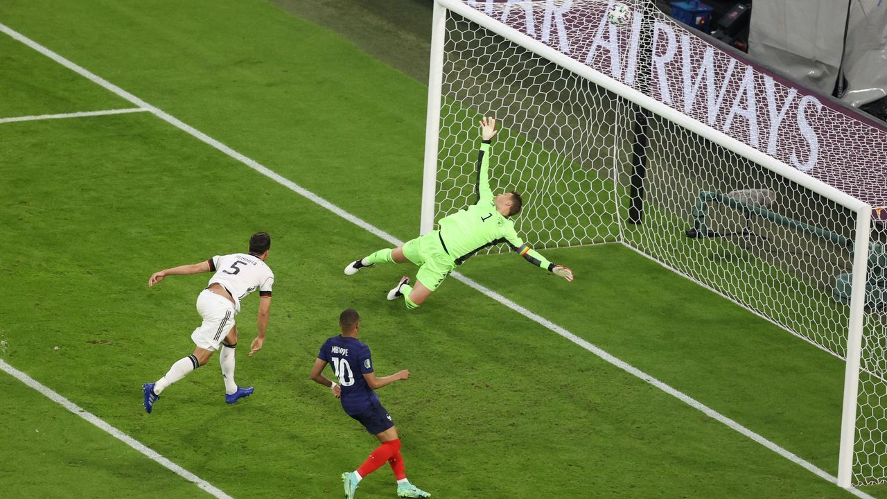 Germany's defender Mats Hummels (L) deflects the ball to score past Germany's goalkeeper Manuel Neuer for the first goal during the UEFA EURO 2020 Group F football match between France and Germany at the Allianz Arena in Munich on June 15, 2021.