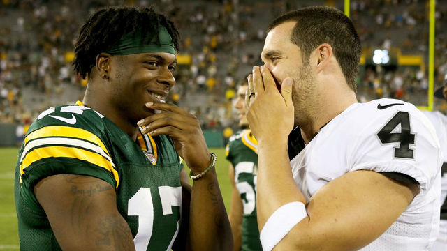 GREEN BAY, WI - AUGUST 18: Davante Adams #17 of the Green Bay Packers and Derek Carr #4 of the Oakland Raiders chat after the preseason game at Lambeau Field on August 18, 2016 in Green Bay, Wisconsin.