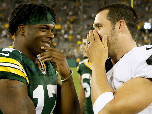 GREEN BAY, WI - AUGUST 18: Davante Adams #17 of the Green Bay Packers and Derek Carr #4 of the Oakland Raiders chat after the preseason game at Lambeau Field on August 18, 2016 in Green Bay, Wisconsin.
