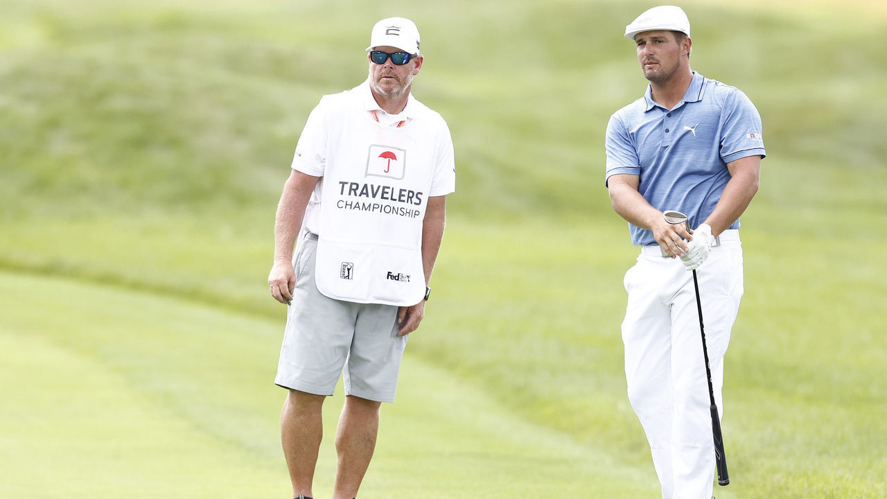 CROMWELL, CONNECTICUT - JUNE 26: Bryson DeChambeau of the United States talks with his caddie Tim Tucker on the seventh hole during the third round of the Travelers Championship at TPC River Highlands on June 26, 2021 in Cromwell, Connecticut.