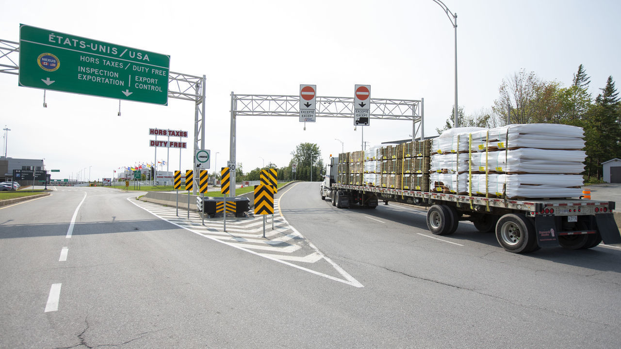 A truck approaches the Canada-U.S. border in Saint-Bernard-de-Lacolle, Quebec, Canada, on Wednesday, Sept. 16, 2020. The U.S. and Canada will extend restrictions on travel across the border until at least Oct. 21, CBC News reported, citing a person with direct knowledge of the situation. Photographer: Christinne Muschi/Bloomberg via Getty Images