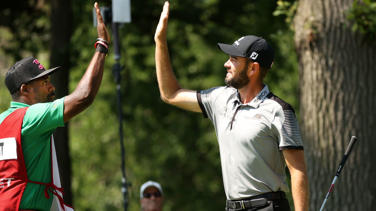 DETROIT, MICHIGAN - JULY 03: Troy Merritt reacts with his caddie Wayne Birch to a hole in one on the 11th green during the third round of the Rocket Mortgage Classic on July 03, 2021 at the Detroit Golf Club in Detroit, Michigan.