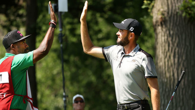 DETROIT, MICHIGAN - JULY 03: Troy Merritt reacts with his caddie Wayne Birch to a hole in one on the 11th green during the third round of the Rocket Mortgage Classic on July 03, 2021 at the Detroit Golf Club in Detroit, Michigan.