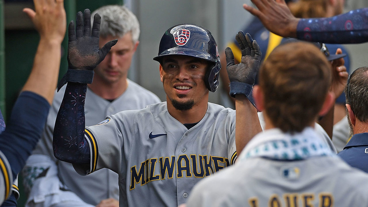 PITTSBURGH, PA - JULY 03: Willy Adames #27 of the Milwaukee Brewers celebrates with teammates in the dugout after coming around to score on a fielding error by Phillip Evans #24 of the Pittsburgh Pirates in the eighth inning during the game at PNC Park on July 3, 2021 in Pittsburgh, Pennsylvania.