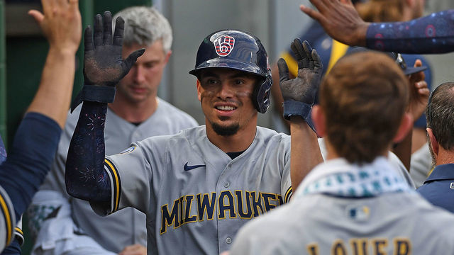 PITTSBURGH, PA - JULY 03: Willy Adames #27 of the Milwaukee Brewers celebrates with teammates in the dugout after coming around to score on a fielding error by Phillip Evans #24 of the Pittsburgh Pirates in the eighth inning during the game at PNC Park on July 3, 2021 in Pittsburgh, Pennsylvania.