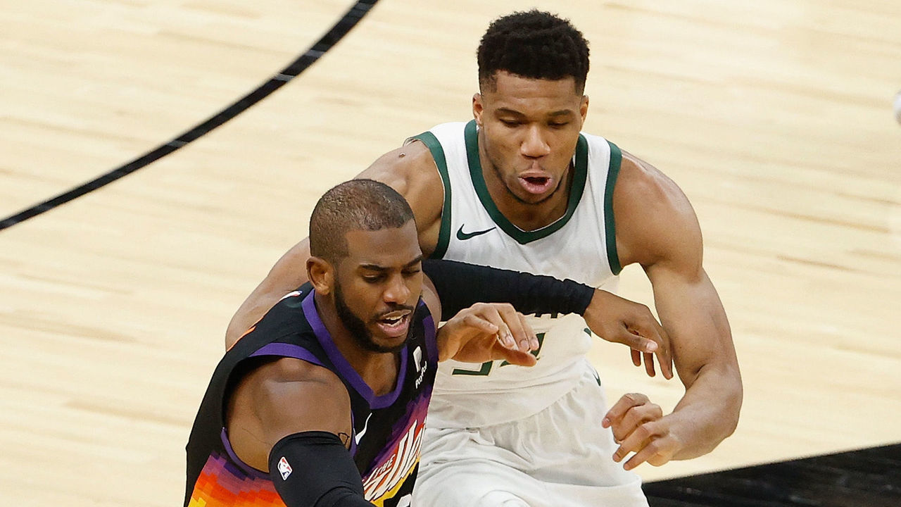 PHOENIX, ARIZONA - FEBRUARY 10: Chris Paul #3 of the Phoenix Suns handle the ball against Giannis Antetokounmpo #34 of the Milwaukee Bucks during the second half of the NBA game at Phoenix Suns Arena on February 10, 2021 in Phoenix, Arizona. The Suns defeated the Bucks 125-124.