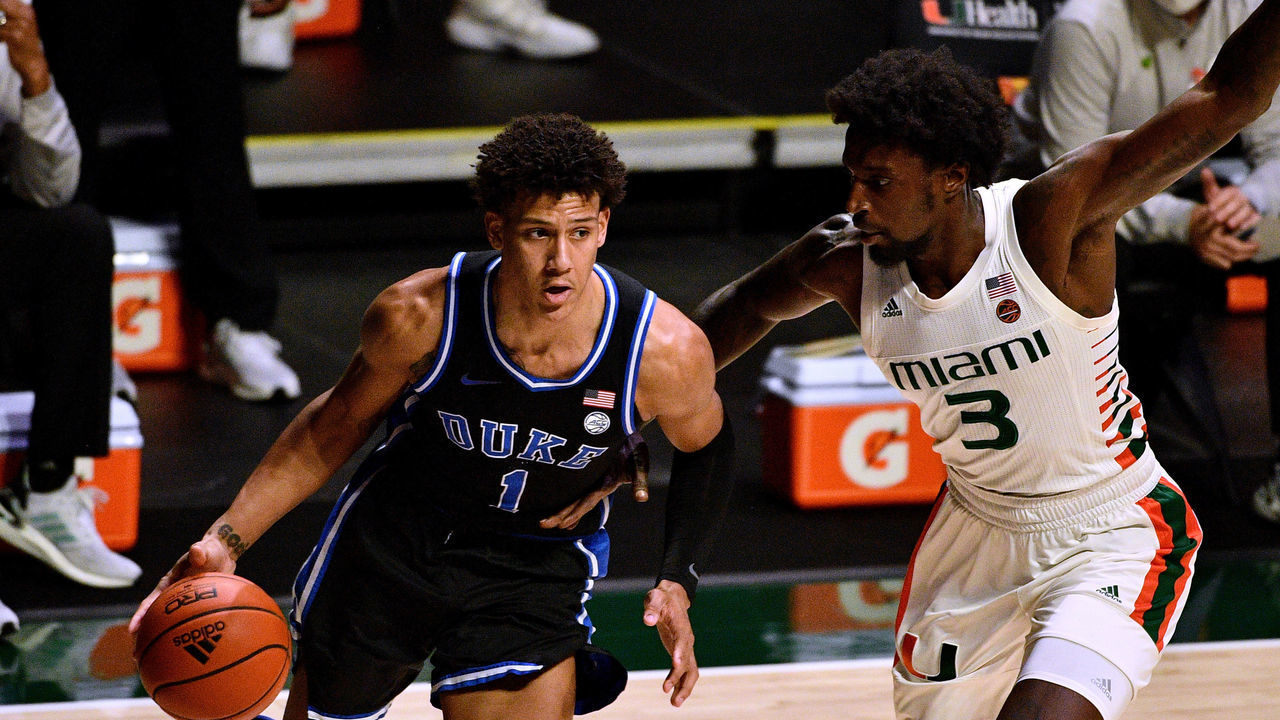 MIAMI, FLORIDA - FEBRUARY 01: Jalen Johnson #1 of the Duke Blue Devils drives to the basket against the Nysier Brooks #3 of the Miami Hurricanes during the first half at Watsco Center on February 01, 2021 in Miami, Florida.