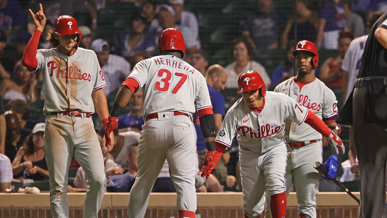 CHICAGO, ILLINOIS - JULY 05: Odubel Herrera #37 of the Philadelphia Phillies is greeted by (L-R) Alec Bohm #28, Ronald Torreyes #74 and Jean Segura #2 of the Philadelphia Phillies after hitting a three run home in the 8th inning against the Chicago Cubs at Wrigley Field on July 05, 2021 in Chicago, Illinois.
