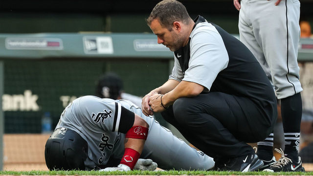 MINNEAPOLIS, MN - JULY 5: Yasmani Grandal #24 of the Chicago White Sox is tended to by a medical trainer during his at-bat against the Minnesota Twins in the sixth inning. Grandal didn't return to the game at Target Field on July 5, 2021 in Minneapolis, Minnesota. The Twins defeated the White Sox 8-5.