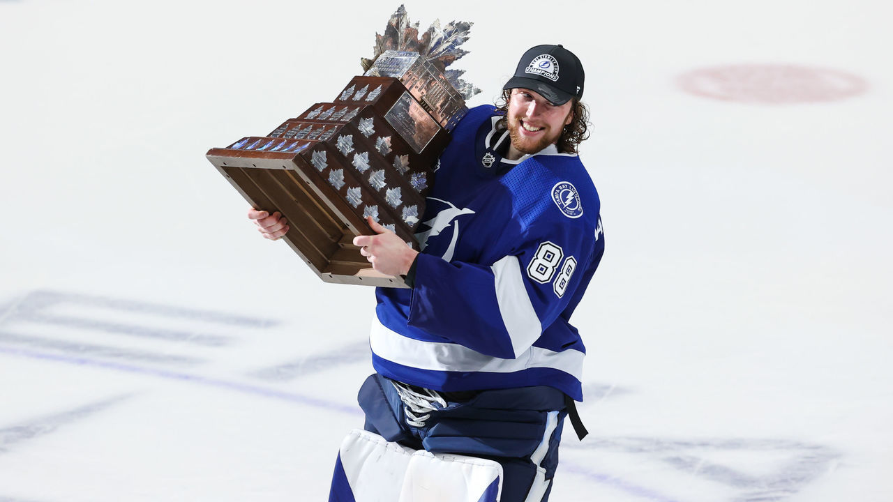 TAMPA, FL - JULY 7: Goalie Andrei Vasilevskiy #88 of the Tampa Bay Lightning celebrates with the Conn Smythe trophy after defeating the Montreal Canadiens in Game Five to win the best of seven game series 4-1 during the Stanley Cup Final of the 2021 Stanley Cup Playoffs at Amalie Arena on July 7, 2021 in Tampa, Florida.