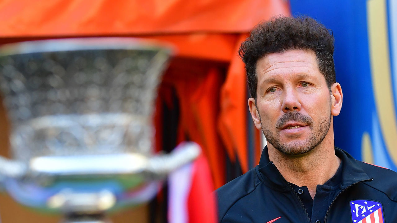 Atletico Madrid's Argentinian coach Diego Simeone poses next to the Spanish Super Cup trophy, on the eve of the final match with Real Madrid at Saudi Arabia's King Abdullah Sports city stadium in the port city of Jeddah, on January 11, 2020.