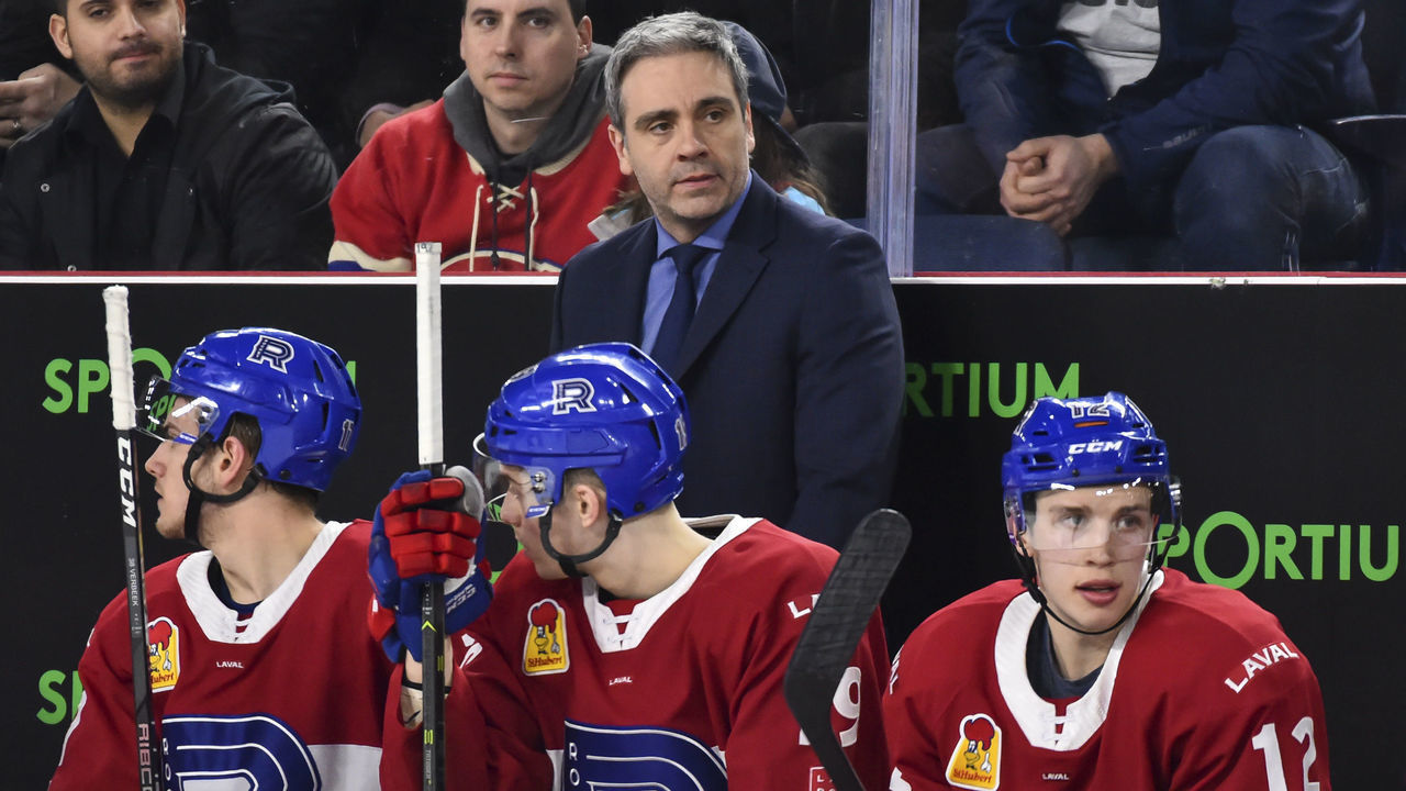 LAVAL, QC - MARCH 20: Head coach of the Laval Rocket Joel Bouchard looks on from behind the bench against the Providence Bruins during the AHL game at Place Bell on March 20, 2019 in Laval, Quebec, Canada. The Laval Rocket defeated the Providence Bruins 3-2 in a shootout.