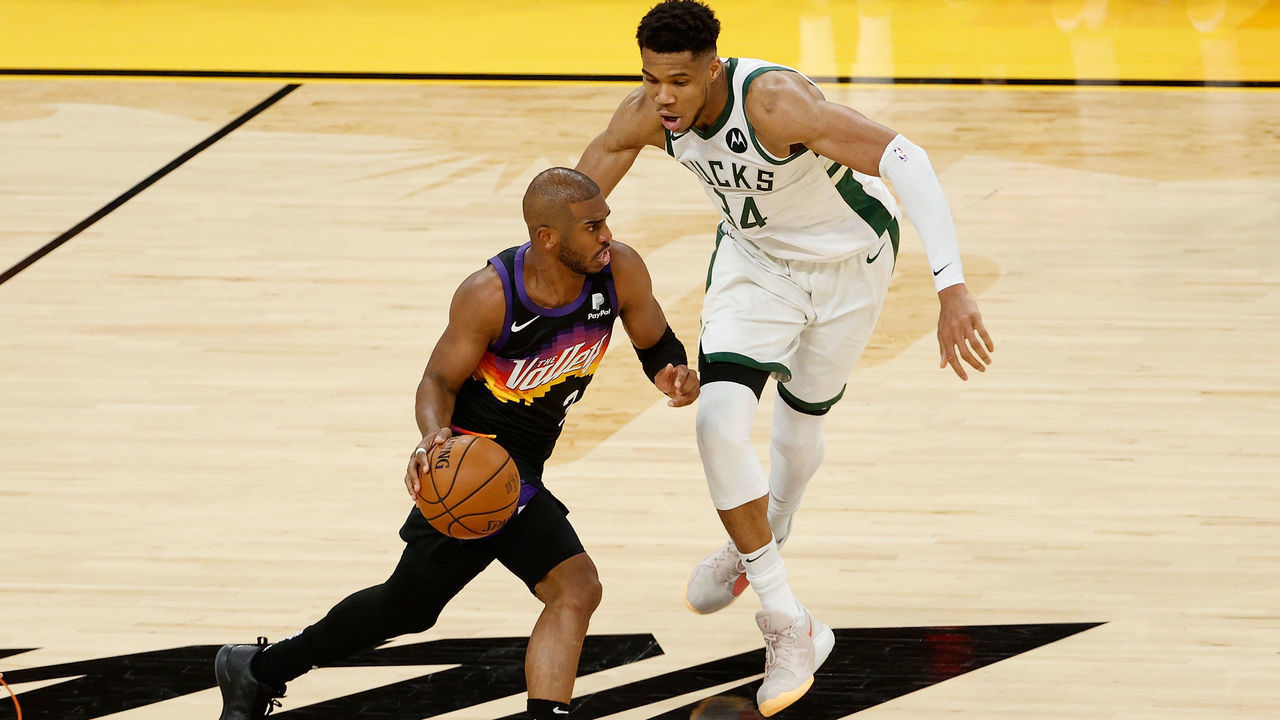 PHOENIX, ARIZONA - JULY 06: Chris Paul #3 of the Phoenix Suns drives the ball past Giannis Antetokounmpo #34 of the Milwaukee Bucks during game one of the NBA Finals at Phoenix Suns Arena on July 06, 2021 in Phoenix, Arizona. The Suns defeated the Bucks 118-105.