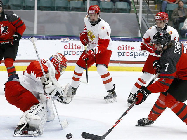 FRISCO, TEXAS - MAY 06: Brennan Othmann #7 of Canada puts a shot on goal against Sergei Ivanov #29 of Russia in the first period during the 2021 IIHF Ice Hockey U18 World Championship Gold Medal Game at Comerica Center on May 06, 2021 in Frisco, Texas.