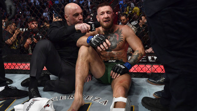 LAS VEGAS, NEVADA - JULY 10: Conor McGregor of Ireland is interviewed by Joe Rogan after his TKO loss due to injury against Dustin Poirier in their welterweight fight during the UFC 264 event at T-Mobile Arena on July 10, 2021 in Las Vegas, Nevada.