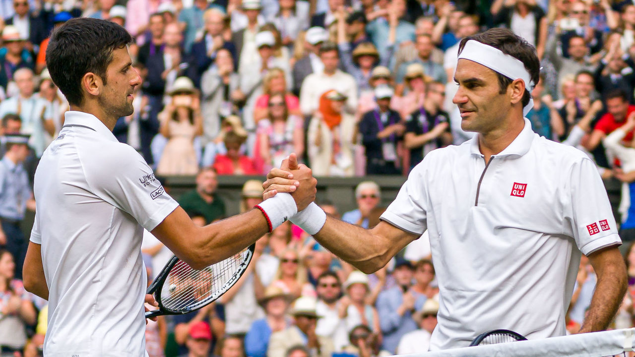LONDON, ENGLAND - JULY 14: Roger Federer of Switzerland shakes hands with Novak Djokovic of Serbia after Novak Djokovic winning his Men's Singles final during Day thirteen of The Championships - Wimbledon 2019 at All England Lawn Tennis and Croquet Club on July 14, 2019 in London, England.