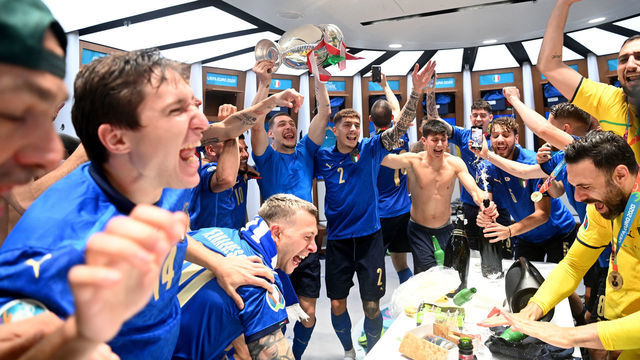 LONDON, ENGLAND - JULY 11: Andrea Belotti of Italy celebrates with team mates as he holds The Henri Delaunay Trophy inside the dressing room following their team's victory in the UEFA Euro 2020 Championship Final between Italy and England at Wembley Stadium on July 11, 2021 in London, England.