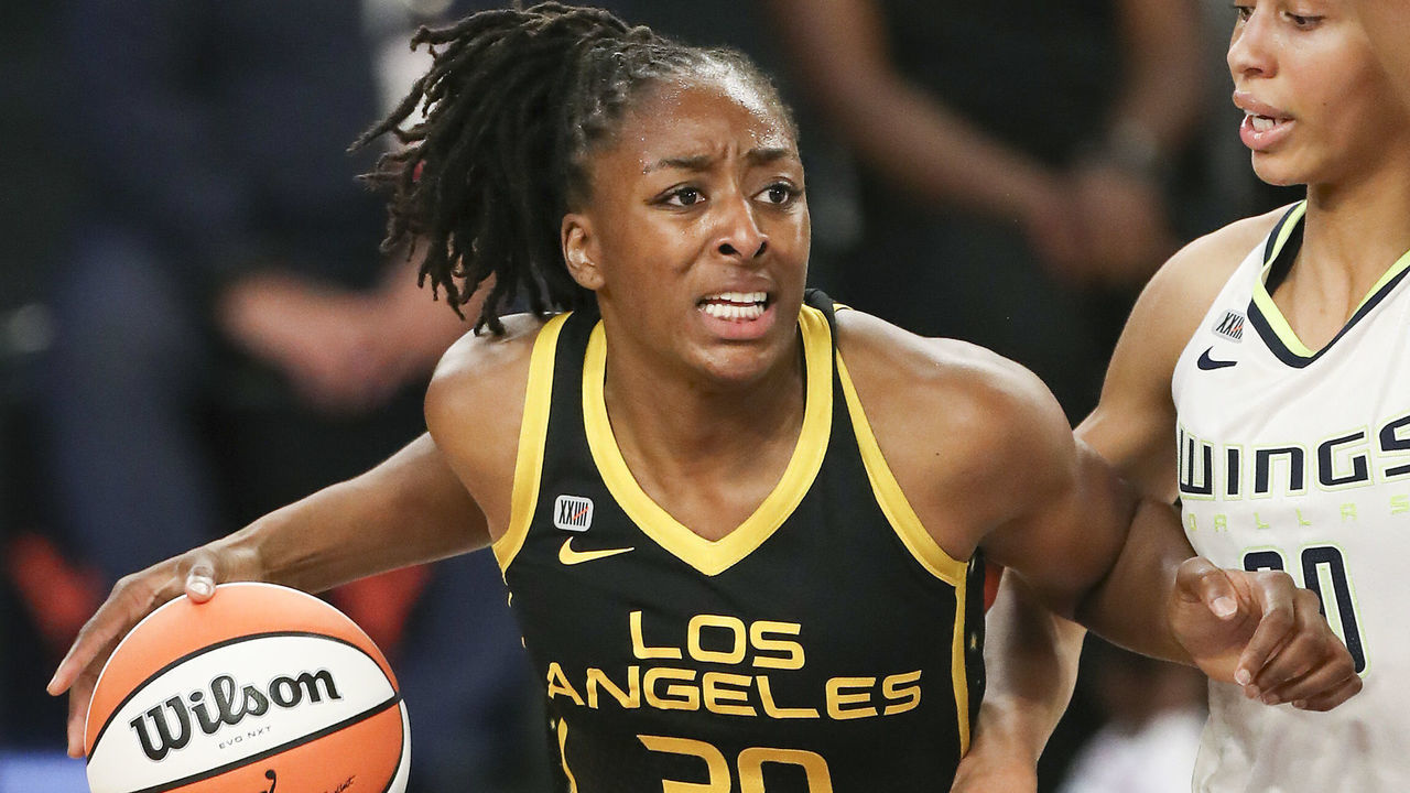 LOS ANGELES, CALIFORNIA - MAY 14: Forward Nneka Ogwumike #30 of the Los Angeles Sparks handles the ball defended by forward Isabelle Harrison #20 of the Dallas Wings at Los Angeles Convention Center on May 14, 2021 in Los Angeles, California.