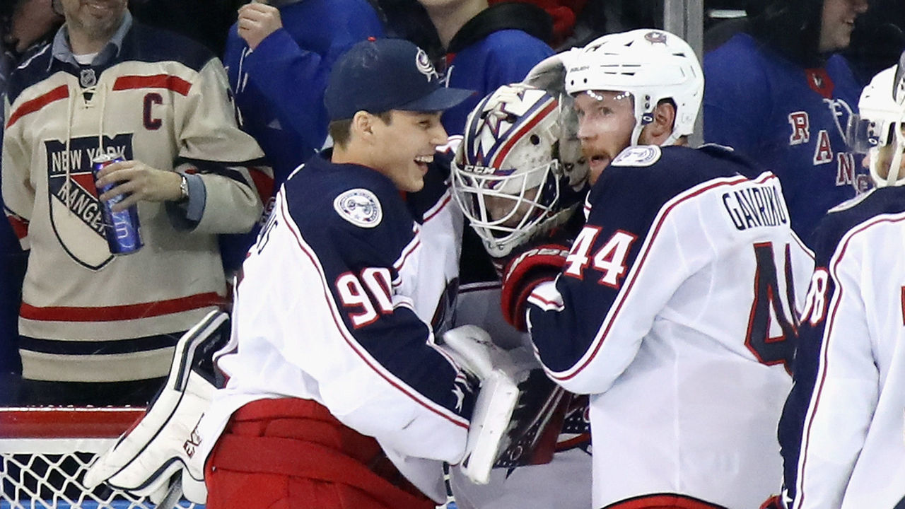 NEW YORK, NEW YORK - JANUARY 19: Fellow Latvia born goaltender Elvis Merzlikins #90 of the Columbus Blue Jackets reaches in to congratulate Matiss Kivlenieks #80 on his first NHL win in his first NHL game against the New York Rangers at Madison Square Garden on January 19, 2020 in New York City. The Blue Jackets defeated the Rangers 2-1.