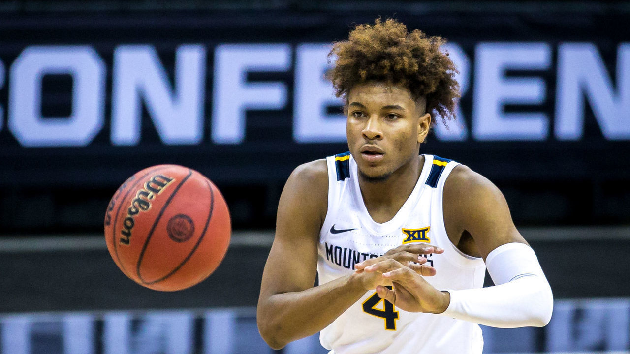 KANSAS CITY, MO - MARCH 11: West Virginia Mountaineers guard Miles McBride (4) passes the ball during the second half against the Oklahoma State Cowboys on March 11th, 2021 at the T Mobile Center in Kansas City, Missouri.