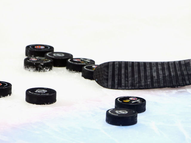 UNIONDALE, NEW YORK - JUNE 03: A close-up view of a stick and pucks during warm-ups prior to the game between the Boston Bruins and the New York Islanders in Game Three of the Second Round of the 2021 NHL Stanley Cup Playoffs at the Nassau Coliseum on June 03, 2021 in Uniondale, New York. The Bruins defeated the Islanders 2-1 in overtime.
