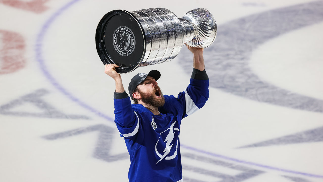 TAMPA, FL - JULY 7: Barclay Goodrow #19 of the Tampa Bay Lightning hoists the Stanley Cup overhead after the Tampa Bay Lightning defeated the Montreal Canadiens in Game Five to win the best of seven game series 4-1 during the Stanley Cup Final of the 2021 Stanley Cup Playoffs at Amalie Arena on July 7, 2021 in Tampa, Florida.