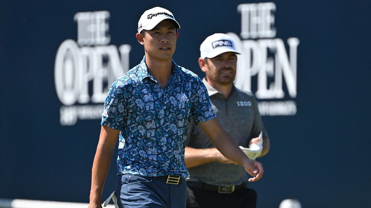 US golfer Collin Morikawa (L) and South Africa's Louis Oosthuizen (R) leave the 1st tee during their final round on day 4 of The 149th British Open Golf Championship at Royal St George's, Sandwich in south-east England on July 18, 2021. - RESTRICTED TO EDITORIAL USE