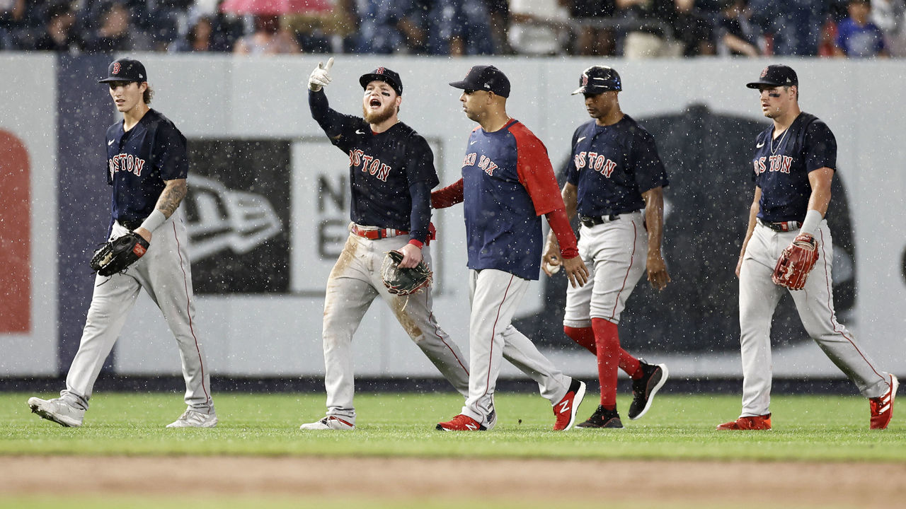 NEW YORK, NY - JULY 17: Alex Verdugo #99 of the Boston Red Sox reacts as he walks off the field with Alex Cora #13 of the Boston Red Sox during the sixth inning against the New York Yankees at Yankee Stadium on July 17, 2021 in the Bronx borough of New York City.