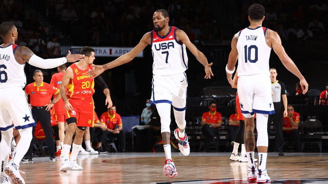 LAS VEGAS, NV - JULY 18: Kevin Durant #7 of the USA Men's National Team high fives Damian Lillard #6 of the USA Men's National Team and Jayson Tatum #10 of the USA Men's National Team during the game against the Spain Men's National Team on July 18, 2021 at Michelob ULTRA Arena in Las Vegas, Nevada.
