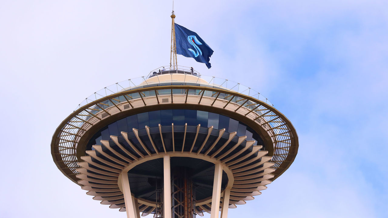 SEATTLE, WASHINGTON - JULY 23: A general view of the Space Needle as the Seattle Kraken team flag is hung from above on July 23, 2020 in Seattle, Washington. The NHL revealed the franchise's new team name today.