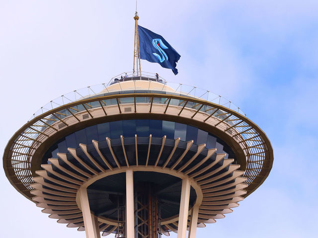 SEATTLE, WASHINGTON - JULY 23: A general view of the Space Needle as the Seattle Kraken team flag is hung from above on July 23, 2020 in Seattle, Washington. The NHL revealed the franchise's new team name today.