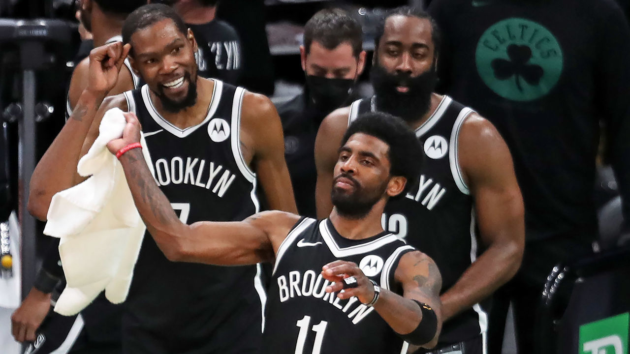 Boston - May 30: The Nets Kyrie Irving waves a towel in celebration as the final seconds ticked off the clock, his teammates Kevin Durant and James Harden are behind him. The Boston Celtics host the Brooklyn Nets in Game Four of their first round NBA Playoff series at the TD Garden in Boston on May 30, 2021.