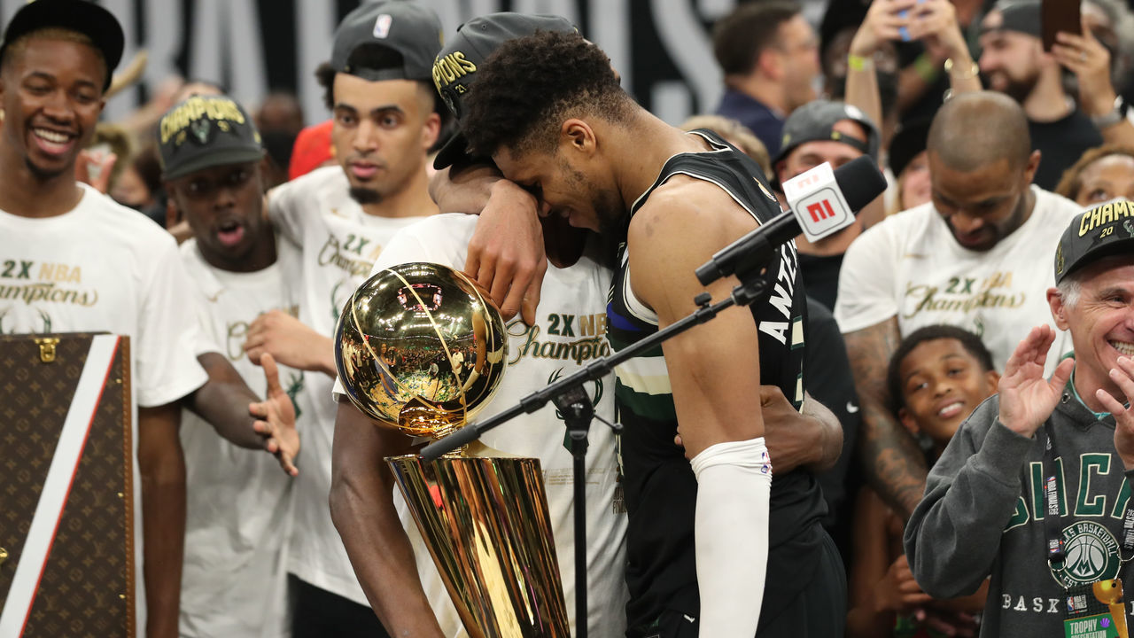 MILWAUKEE, WI - July 17: Khris Middleton #22 of the Milwaukee Bucks hugs Giannis Antetokounmpo #34 of the Milwaukee Bucks with the Larry O'Brien trophy after winning the 2021 NBA Finals on July 17, 2021 at Fiserv Forum in Milwaukee, Wisconsin. Mandatory Copyright Notice: Copyright 2021 NBAE