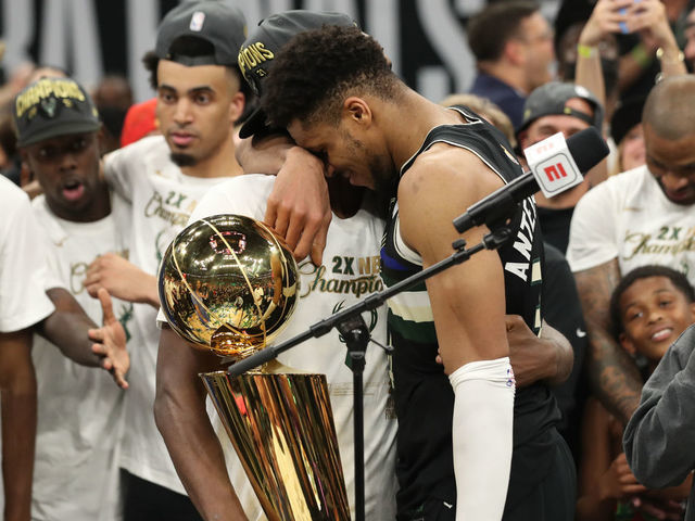 MILWAUKEE, WI - July 17: Khris Middleton #22 of the Milwaukee Bucks hugs Giannis Antetokounmpo #34 of the Milwaukee Bucks with the Larry O'Brien trophy after winning the 2021 NBA Finals on July 17, 2021 at Fiserv Forum in Milwaukee, Wisconsin. Mandatory Copyright Notice: Copyright 2021 NBAE