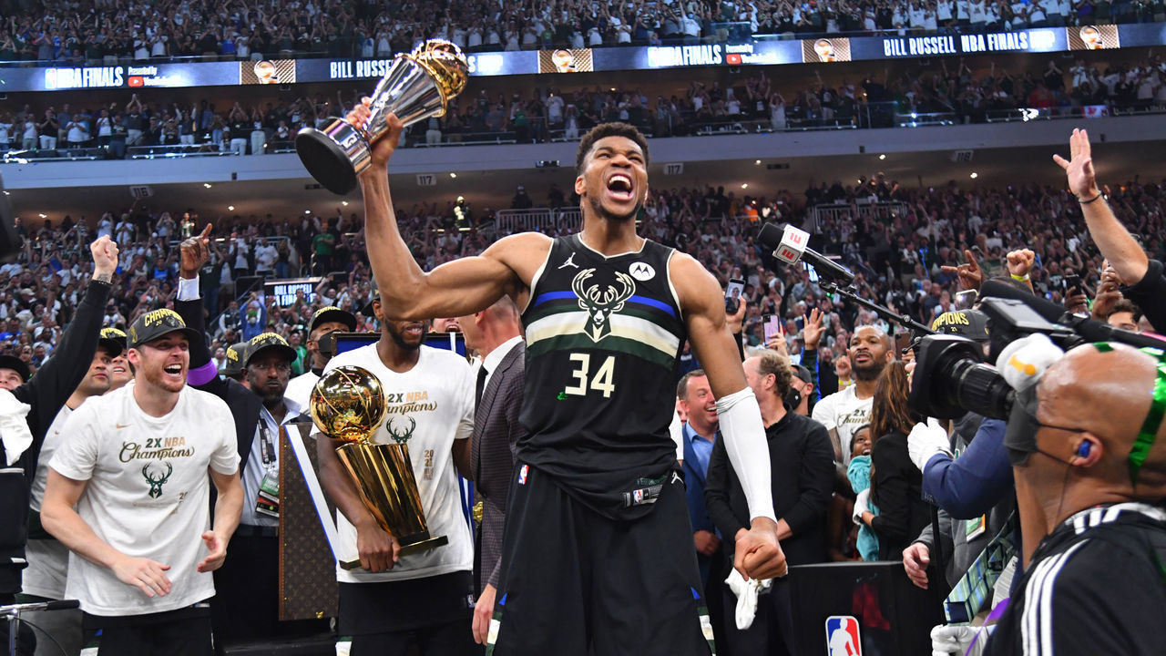 MILWAUKEE, WI - JULY 20: Giannis Antetokounmpo #34 of the Milwaukee Bucks celebrates after receiving the Bill Russell Finals MVP Award after winning Game Six of the 2021 NBA Finals against the Phoenix Suns on July 20, 2021 at Fiserv Forum in Milwaukee, Wisconsin. NOTE TO USER: User expressly acknowledges and agrees that, by downloading and/or using this Photograph, user is consenting to the terms and conditions of the Getty Images License Agreement. Mandatory Copyright Notice: Copyright 2021 NBAE