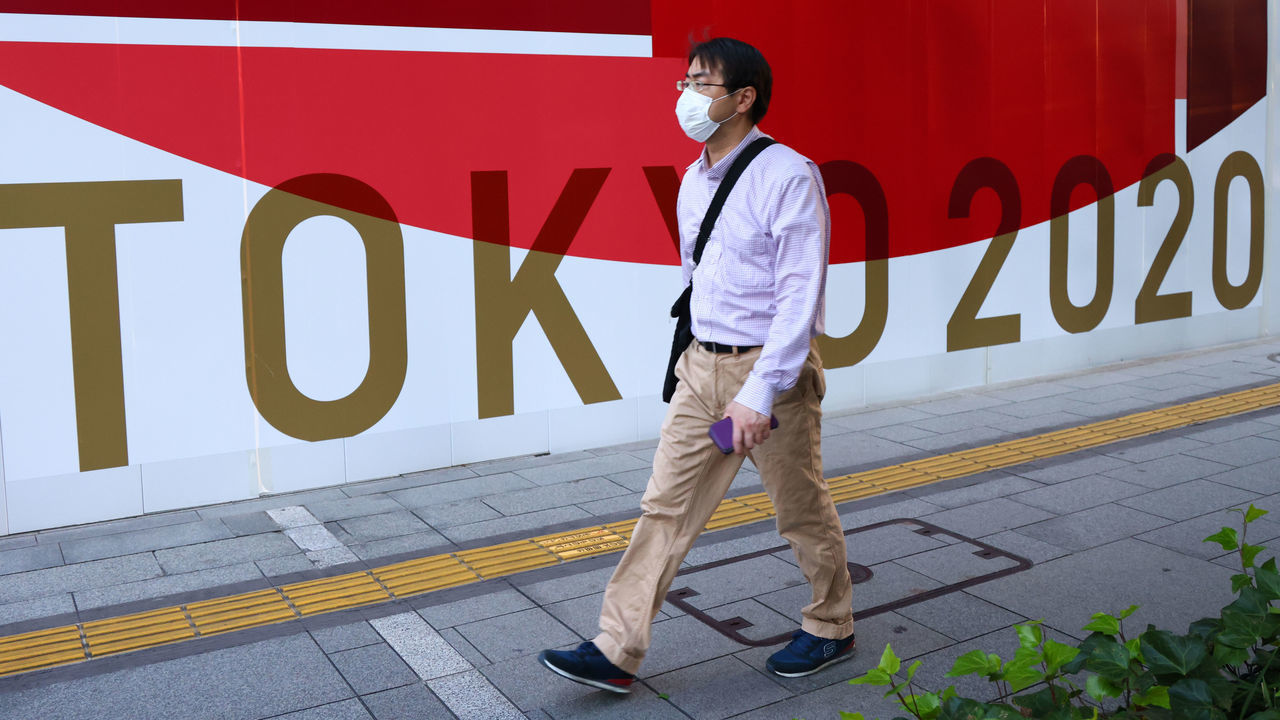 TOKYO, JAPAN - JULY 21, 2021: A man walks along in the city's centre. Tokyo was to host the 2020 Summer Olympic Games on July 24-August 9, 2020. The games were postponed for a year due to the COVID-19 pandemic, and are scheduled to take place on July 23-August 8, 2021. Valery Sharifulin/TASS