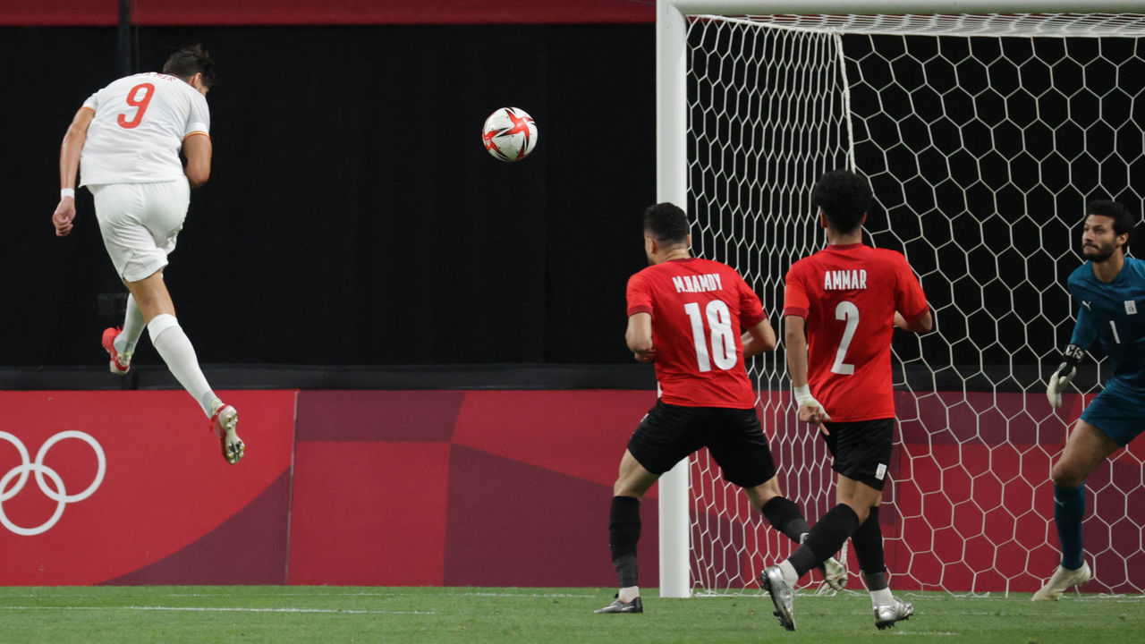 Spain's forward Rafa Mir (L) heads a shot towards the Egyptian goal during the Tokyo 2020 Olympic Games men's group C first round football match between Egypt and Spain at Sapporo Dome in Sapporo on July 22, 2021.