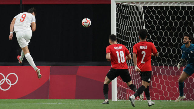 Spain's forward Rafa Mir (L) heads a shot towards the Egyptian goal during the Tokyo 2020 Olympic Games men's group C first round football match between Egypt and Spain at Sapporo Dome in Sapporo on July 22, 2021.