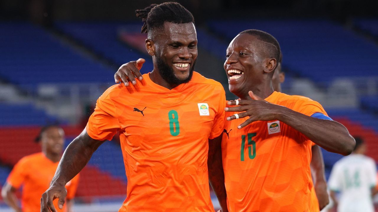 Ivory Coast's midfielder Franck Kessie (L) celebrates with Ivory Coast's forward Max Gradel after he scored his side's second goal during the Tokyo 2020 Olympic Games men's group D first round football match between Ivory Coast and Saudi Arabia at the Yokohama International Stadium in Yokohama on July 22, 2021.