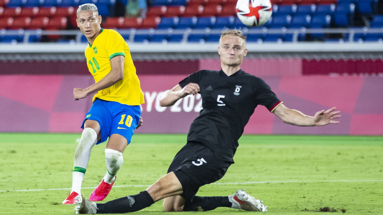 YOKOHAMA, JAPAN - JULY 22: (BILD ZEITUNG OUT) Richarlison of Brazil scores the goal to 3:0 against Amos Pieper of Germany in the Men's First Round Group D match between Brazil and Germany during the Tokyo 2020 Olympic Games at International Stadium Yokohama on July 22, 2021 in Yokohama, Kanagawa, Japan.