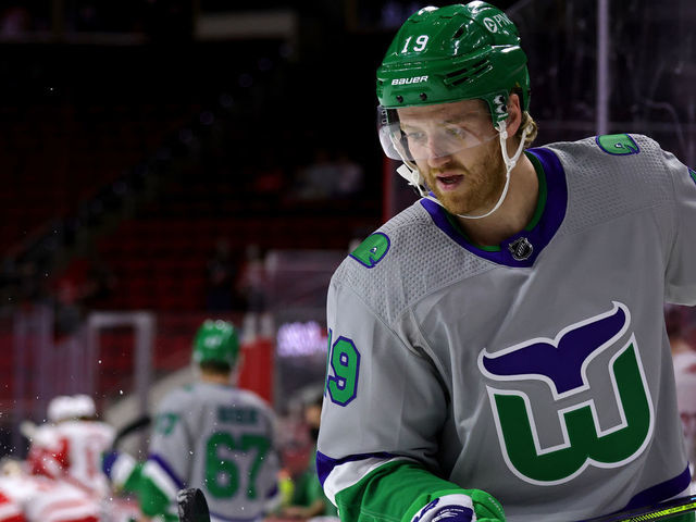 RALEIGH, NC - APRIL 10: Dougie Hamilton #19 of the Carolina Hurricanes juggles a puck prior to an NHL game against the Detroit Red Wings on April 10, 2021 at PNC Arena in Raleigh, North Carolina.