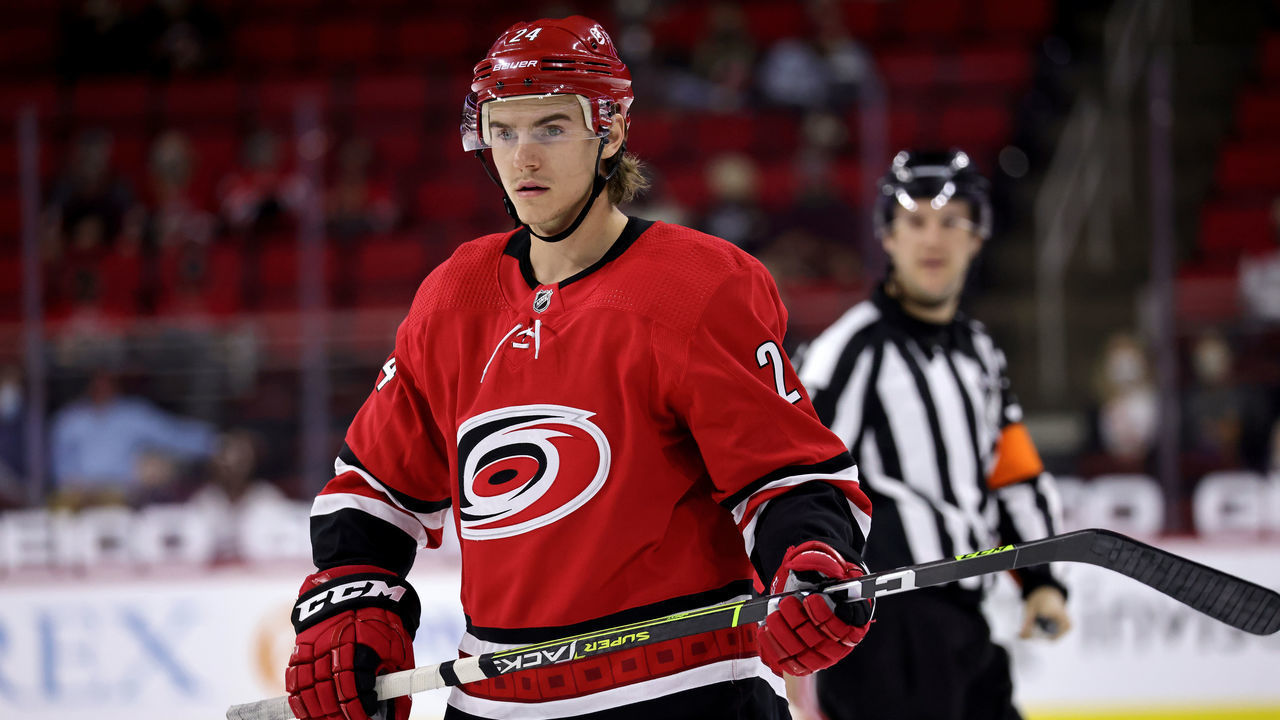 RALEIGH, NC - MAY 4: Jake Bean #24 of the Carolina Hurricanes prepares for a face-off during an NHL game against the Chicago Blackhawks on May 4, 2021 at PNC Arena in Raleigh, North Carolina.