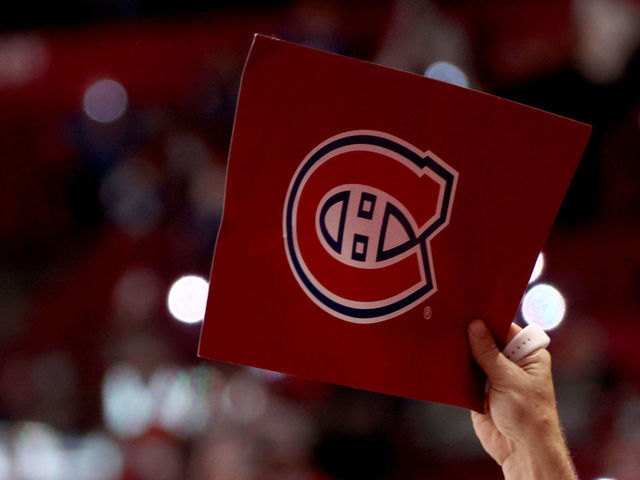 MONTREAL, QUEBEC - JULY 05: A fan of the Montreal Canadiens holds up a cardboard placard with a Canadiens logo after the overtime game-winning goal by Josh Anderson #17 of the Montreal Canadiens (not in photo) in the first over time of Game Four of the 2021 Stanley Cup Final against the Tampa Bay Lightning at Bell Centre on July 05, 2021 in Montreal, Quebec.