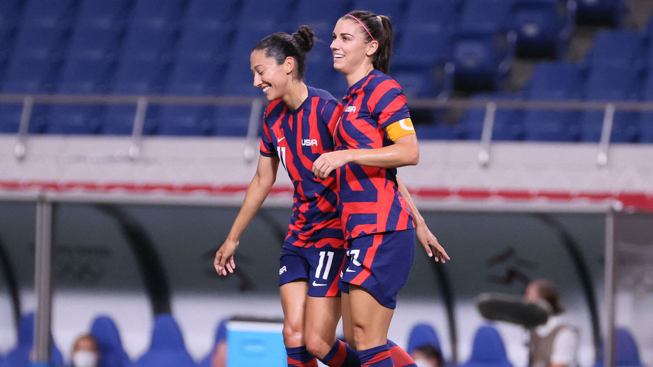 USA's forward Christen Press (L) and USA's forward Alex Morgan (R) celebrate their sixth goal during the Tokyo 2020 Olympic Games women's group G first round football match between New Zealand and USA at the Saitama Stadium in Saitama on July 24, 2021.