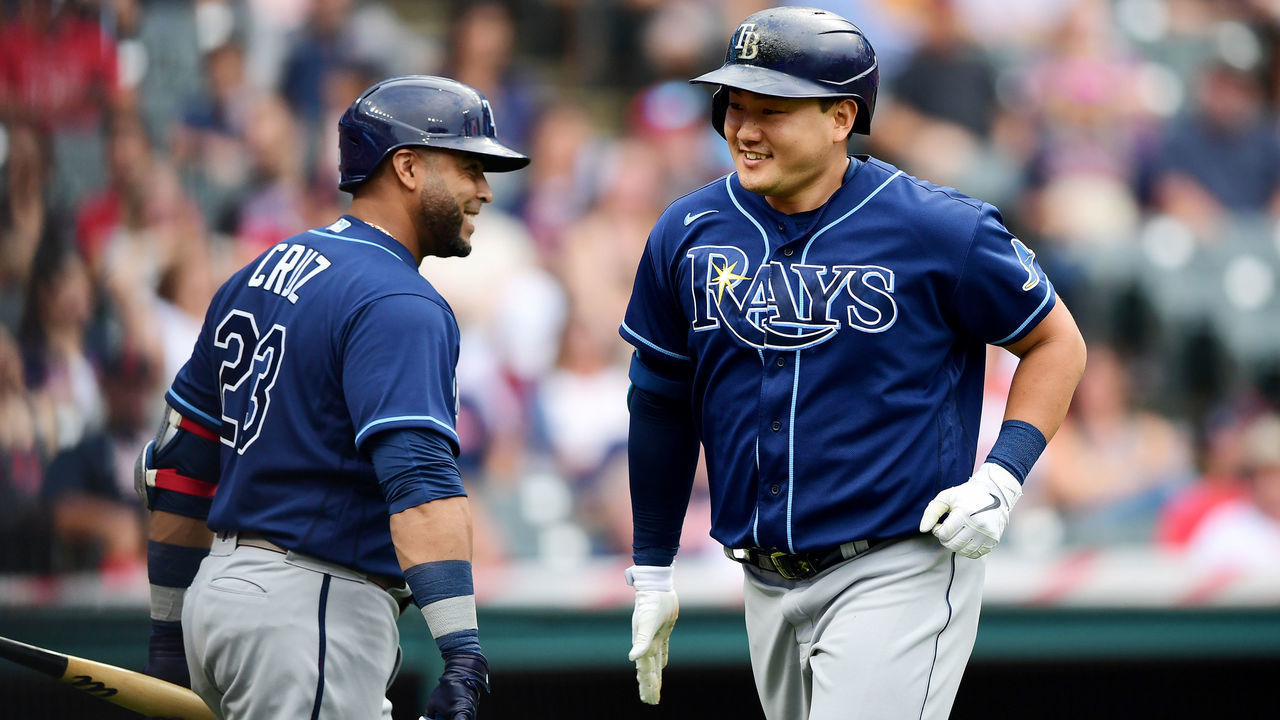 CLEVELAND, OHIO - JULY 24: Ji-Man Choi #26 celebrates with Nelson Cruz #23 of the Tampa Bay Rays after Choi's solo home run in the first inning during their game against the Cleveland Indians at Progressive Field on July 24, 2021 in Cleveland, Ohio.