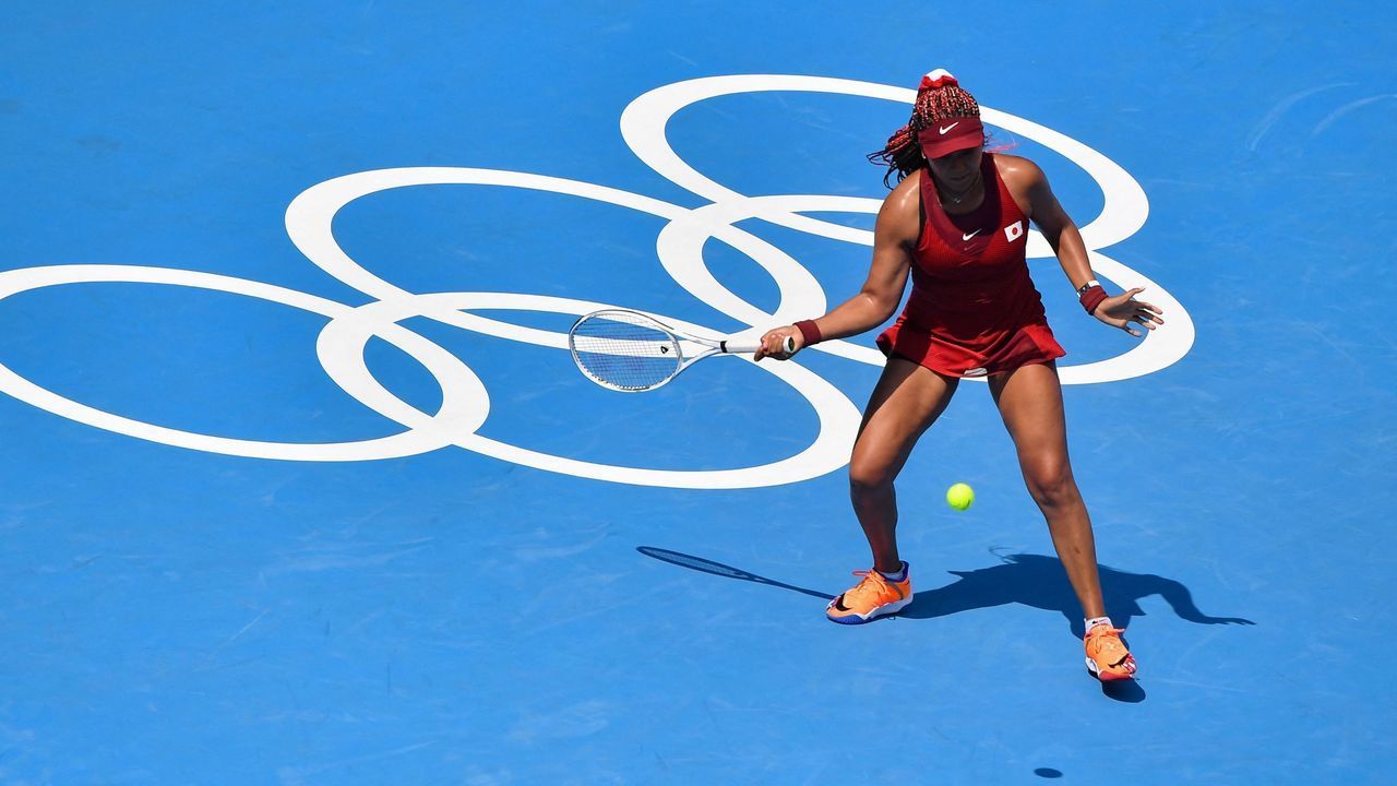 Japan's Naomi Osaka returns a shot to China's Zheng Saisai during their Tokyo 2020 Olympic Games women's singles first round tennis match at the Ariake Tennis Park in Tokyo on July 25, 2021.