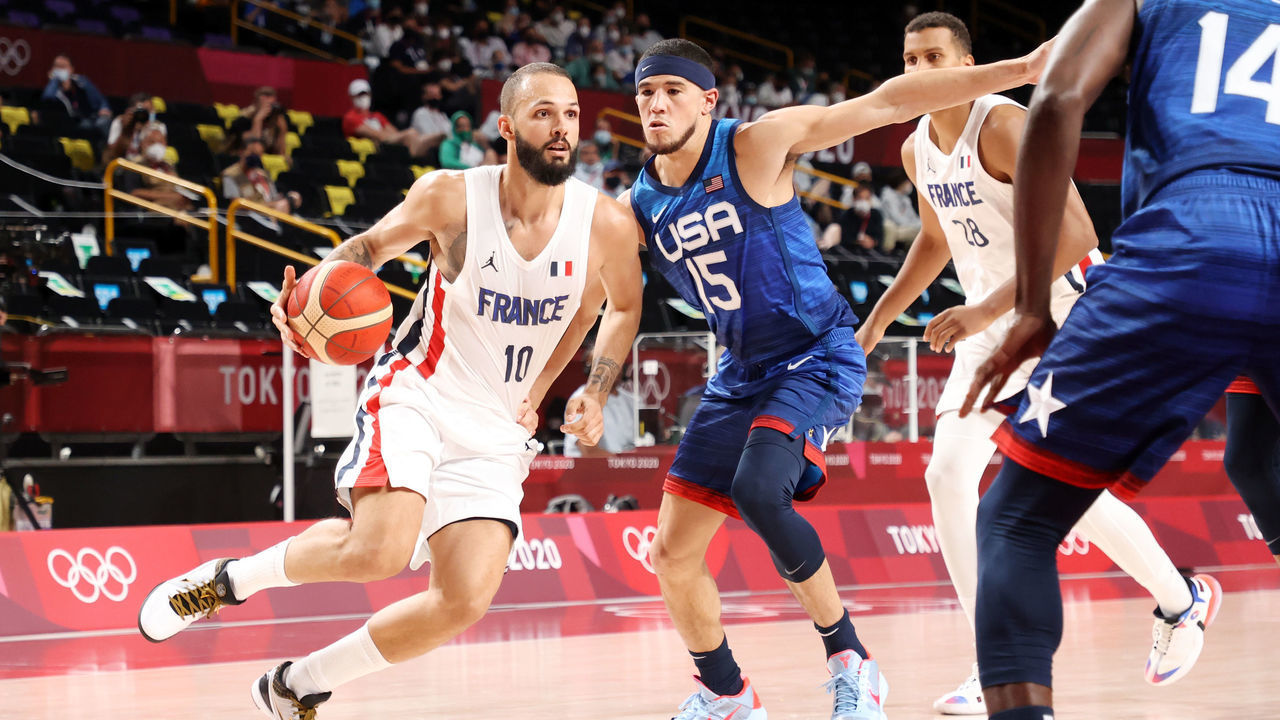 SAITAMA, JAPAN - JULY 25: Evan Fournier #10 of Team France drives past Devin Booker #15 of Team United States during the second half of the Men's Preliminary Round Group B game on day two of the Tokyo 2020 Olympic Games at Saitama Super Arena on July 25, 2021 in Saitama, Japan.